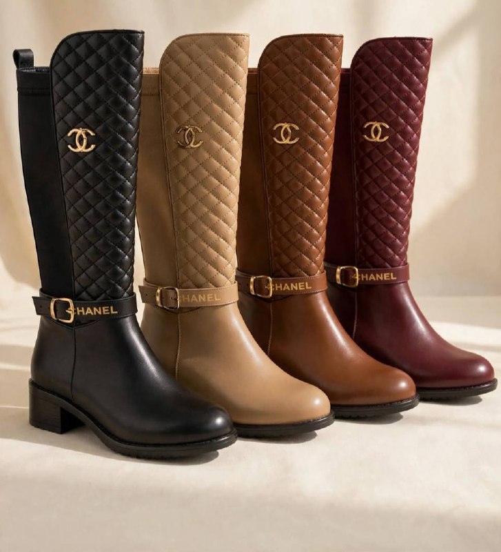 Four Chanel quilted knee-high boots in black, beige, brown, and burgundy, lined up side-by-side on a light beige background. Each boot features a quilted shaft, a gold-tone CC logo, a decorative ankle strap with a gold buckle, and a low block heel.