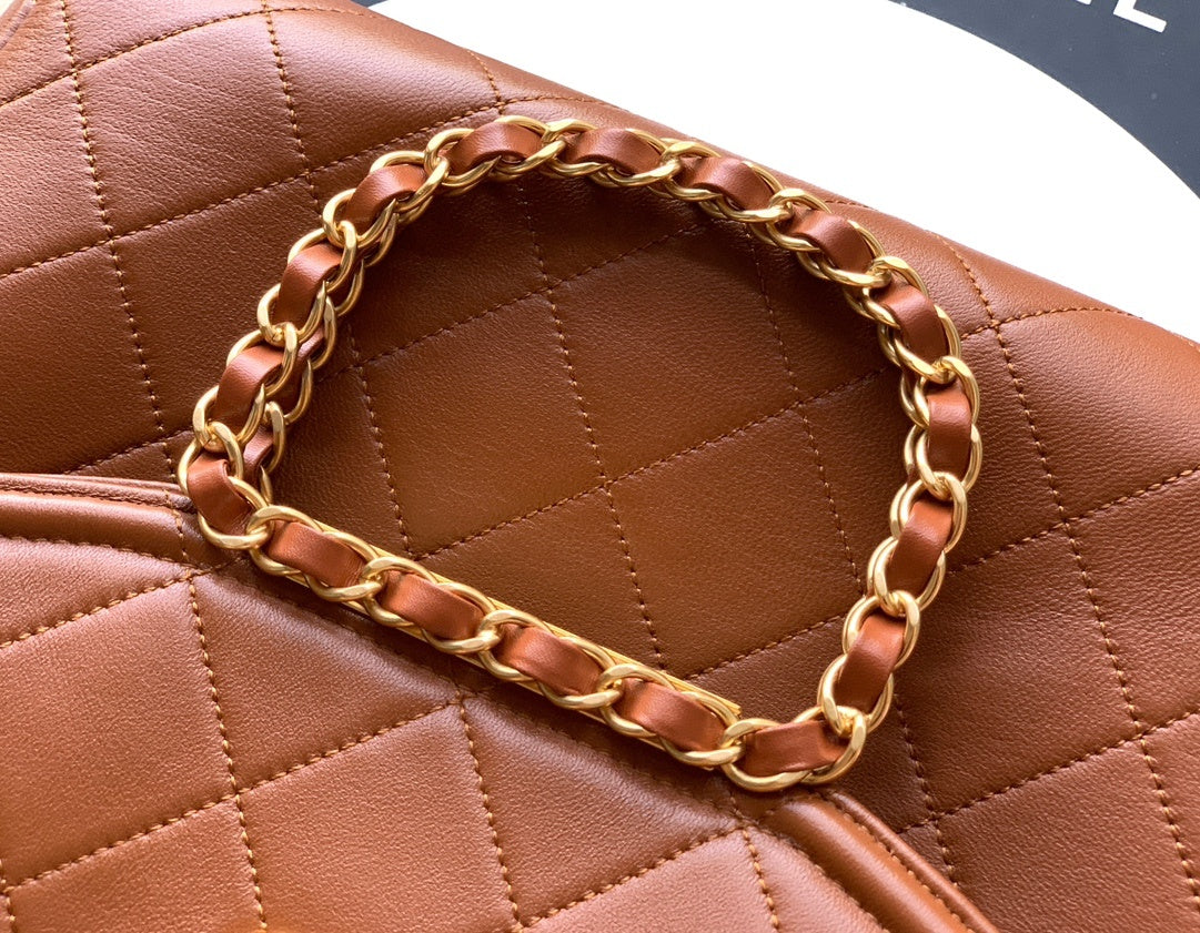 Brown quilted handbag with a gold chain detail