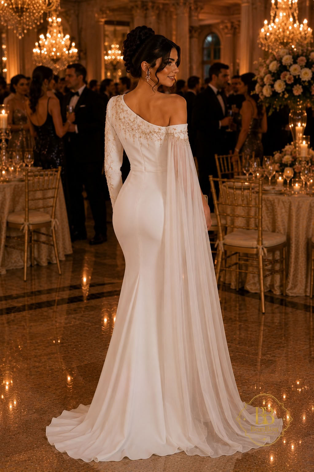 A woman wearing a formal off-the-shoulder wedding gown with long sheer sleeves and a flowing train, standing in a grand ballroom with guests and chandeliers in the background.